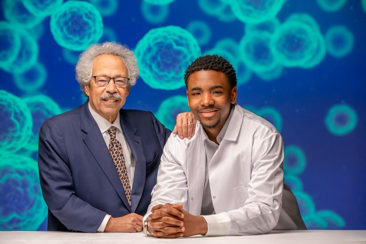 Hanif and Dr. Mitchell standing together